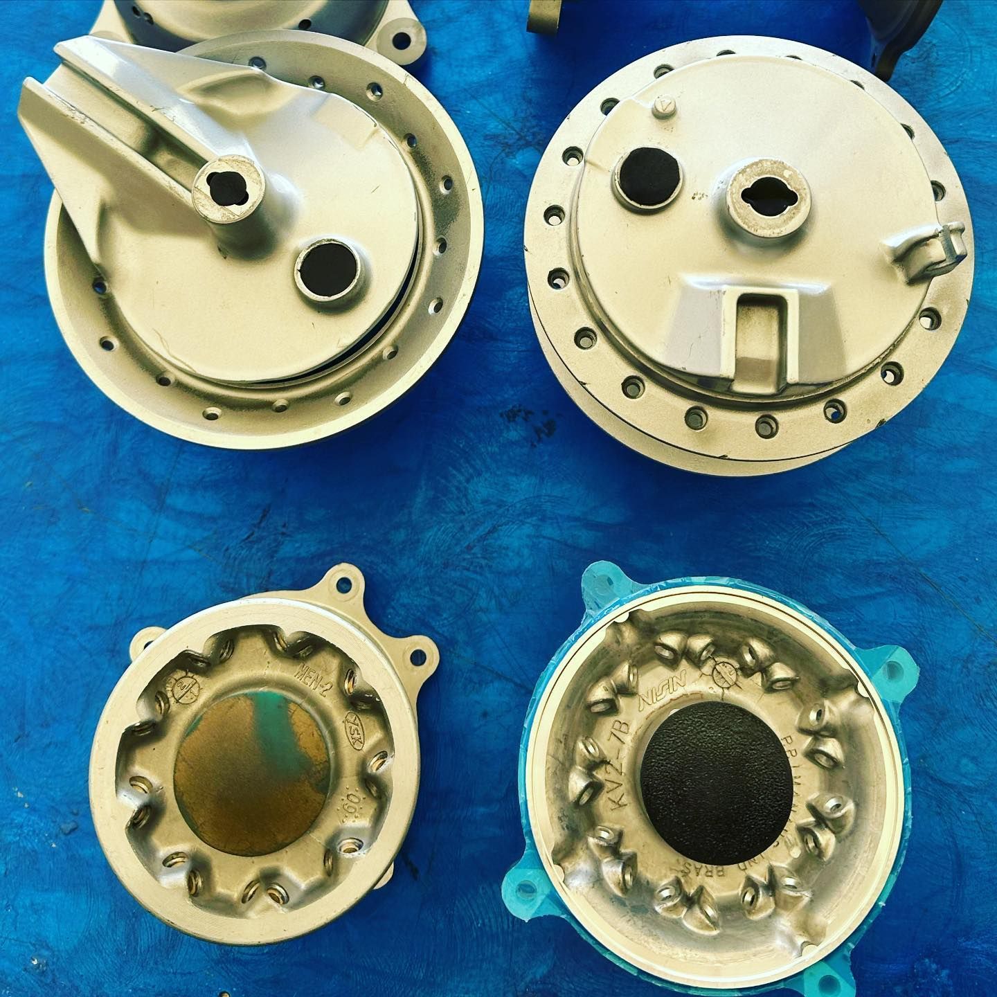 A bunch of metal parts on a blue surface