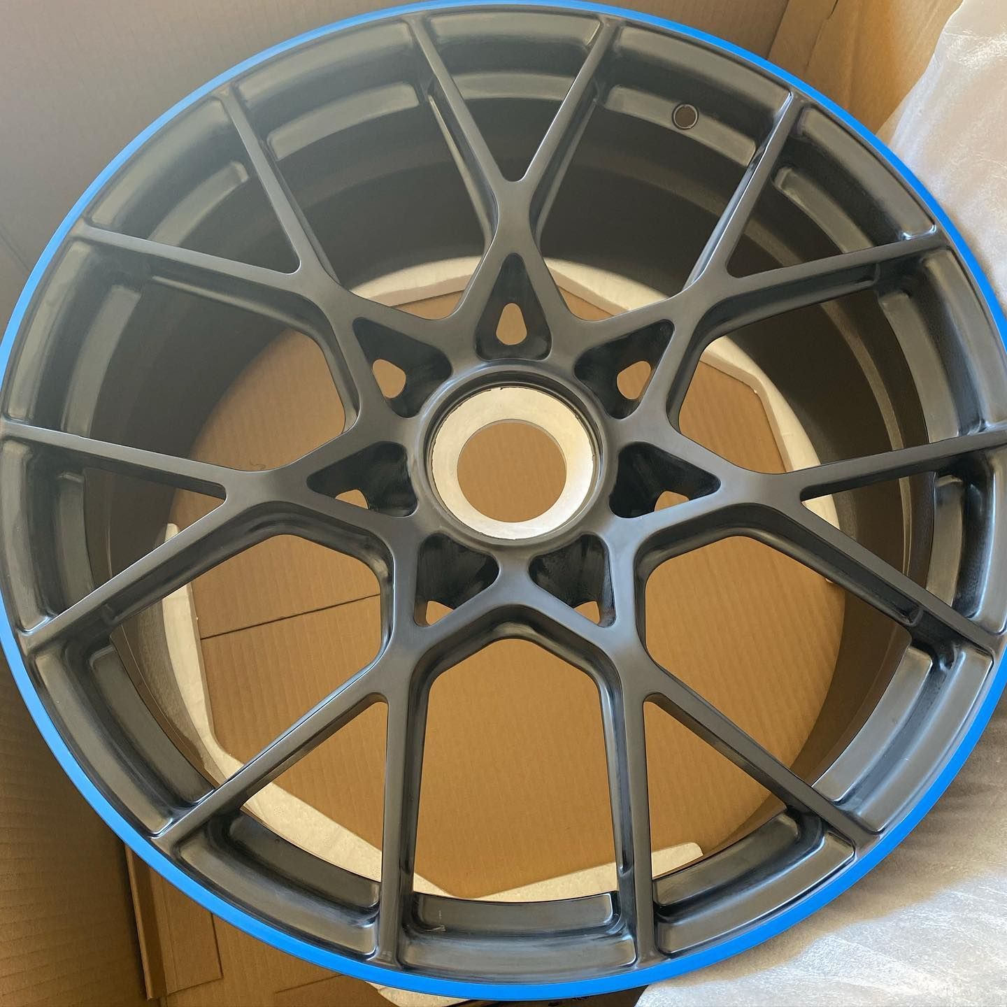 A close up of a wheel with a blue rim