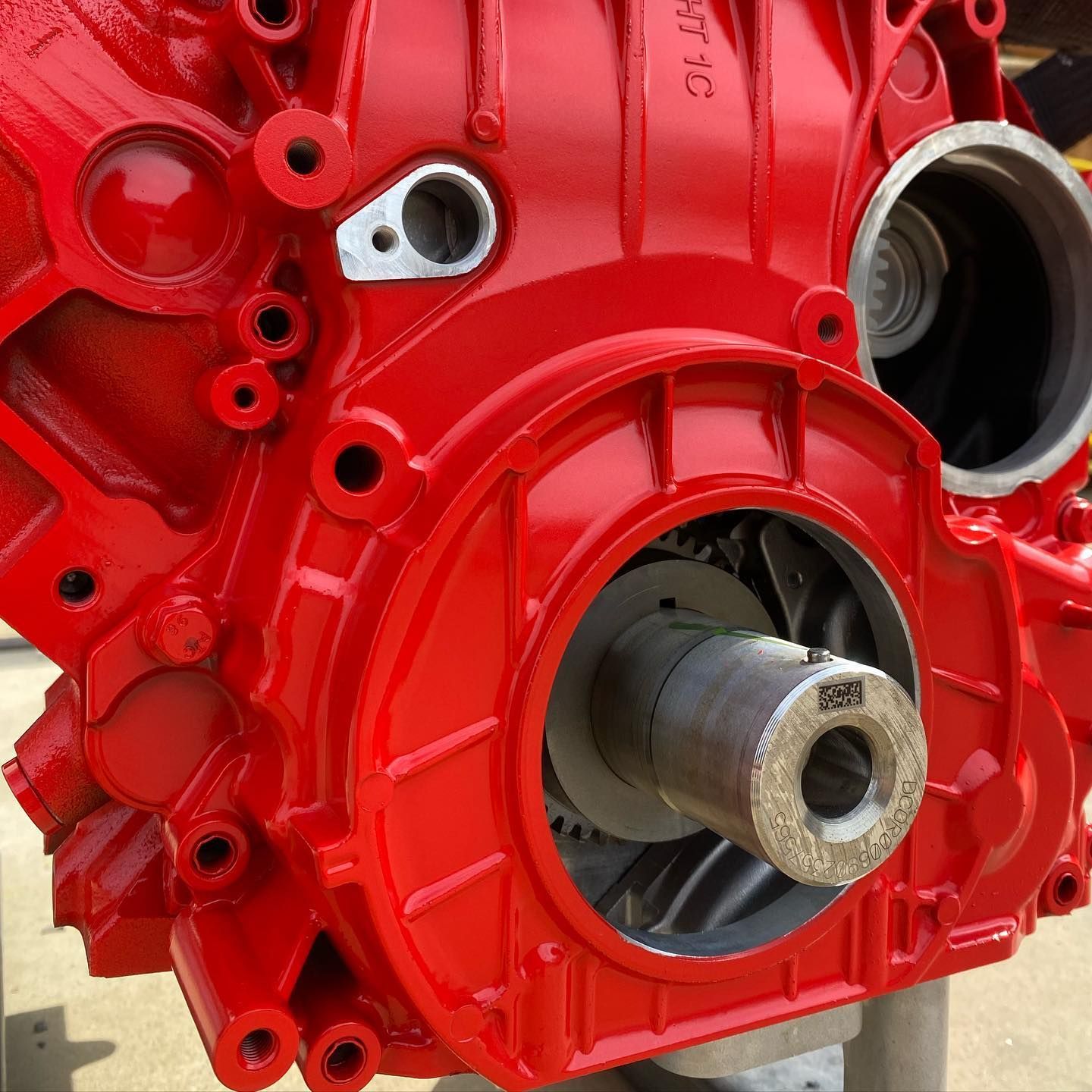 A close up of a red engine with a gear in it