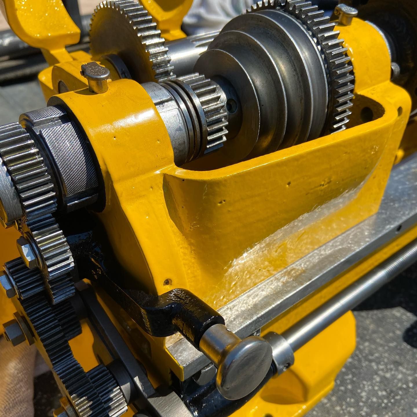 A close up of a yellow machine with gears on it