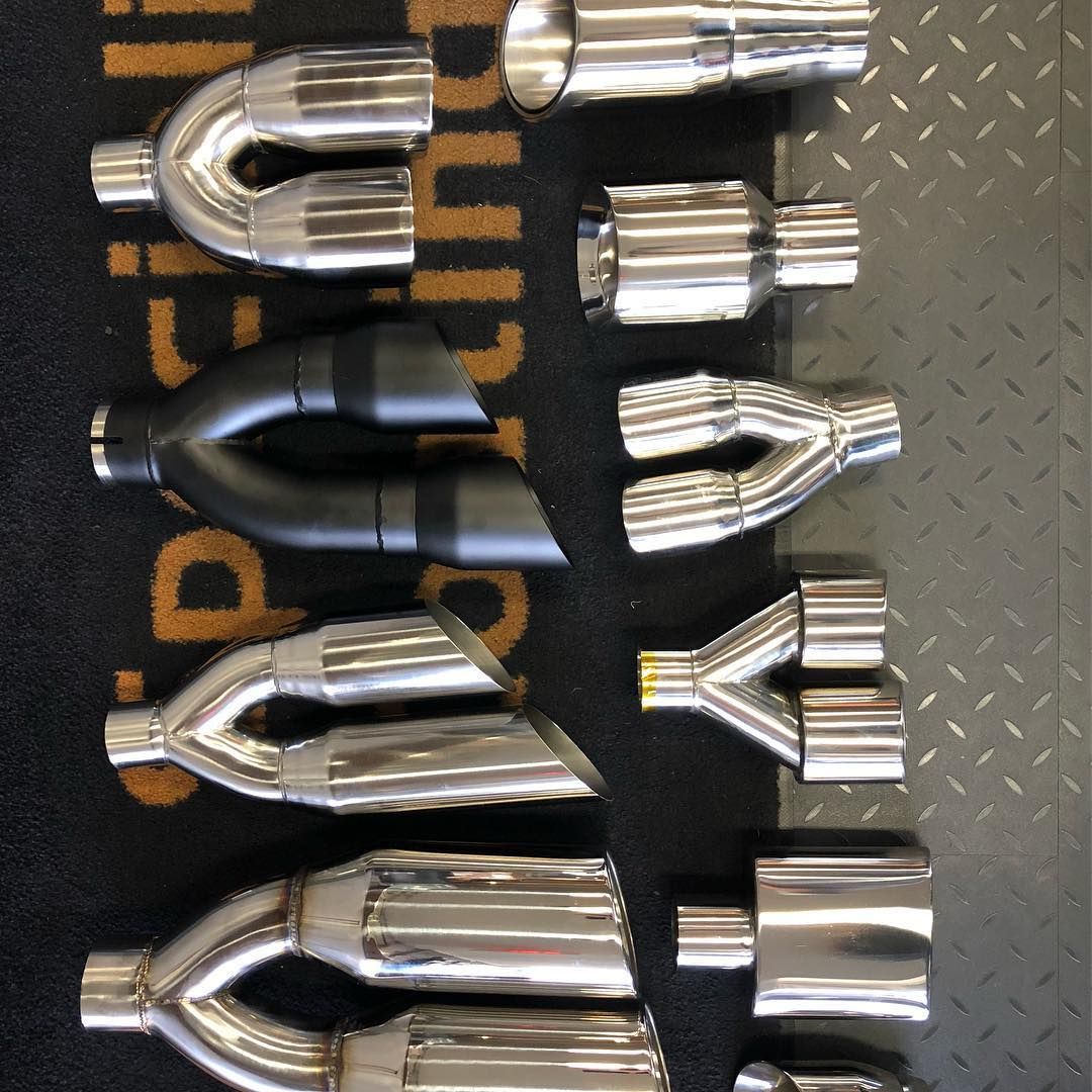 A bunch of exhaust pipes are lined up in a row