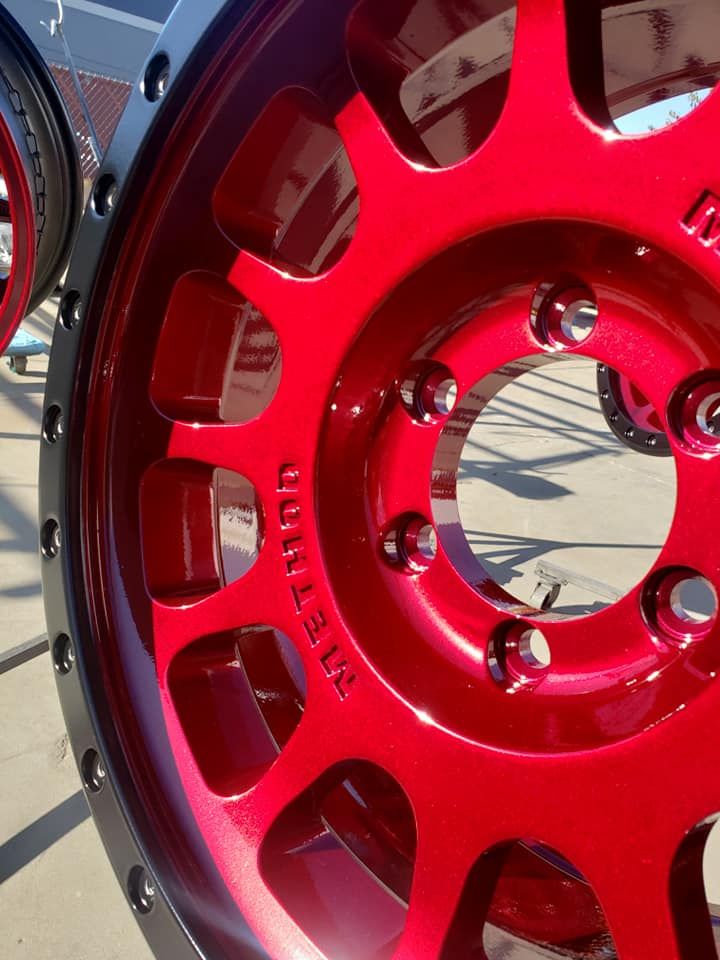 A close up of a red jeep wheel