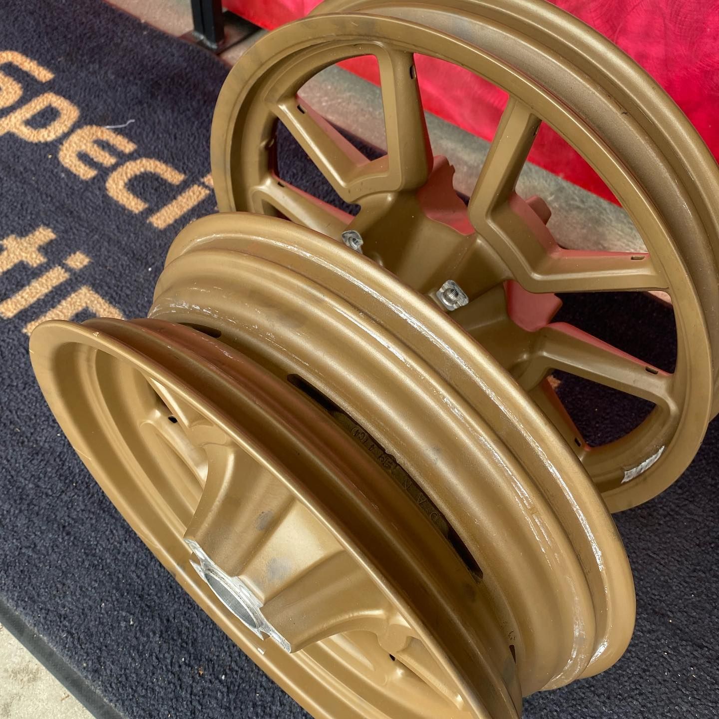 A pair of wheels are sitting on a mat that says specific