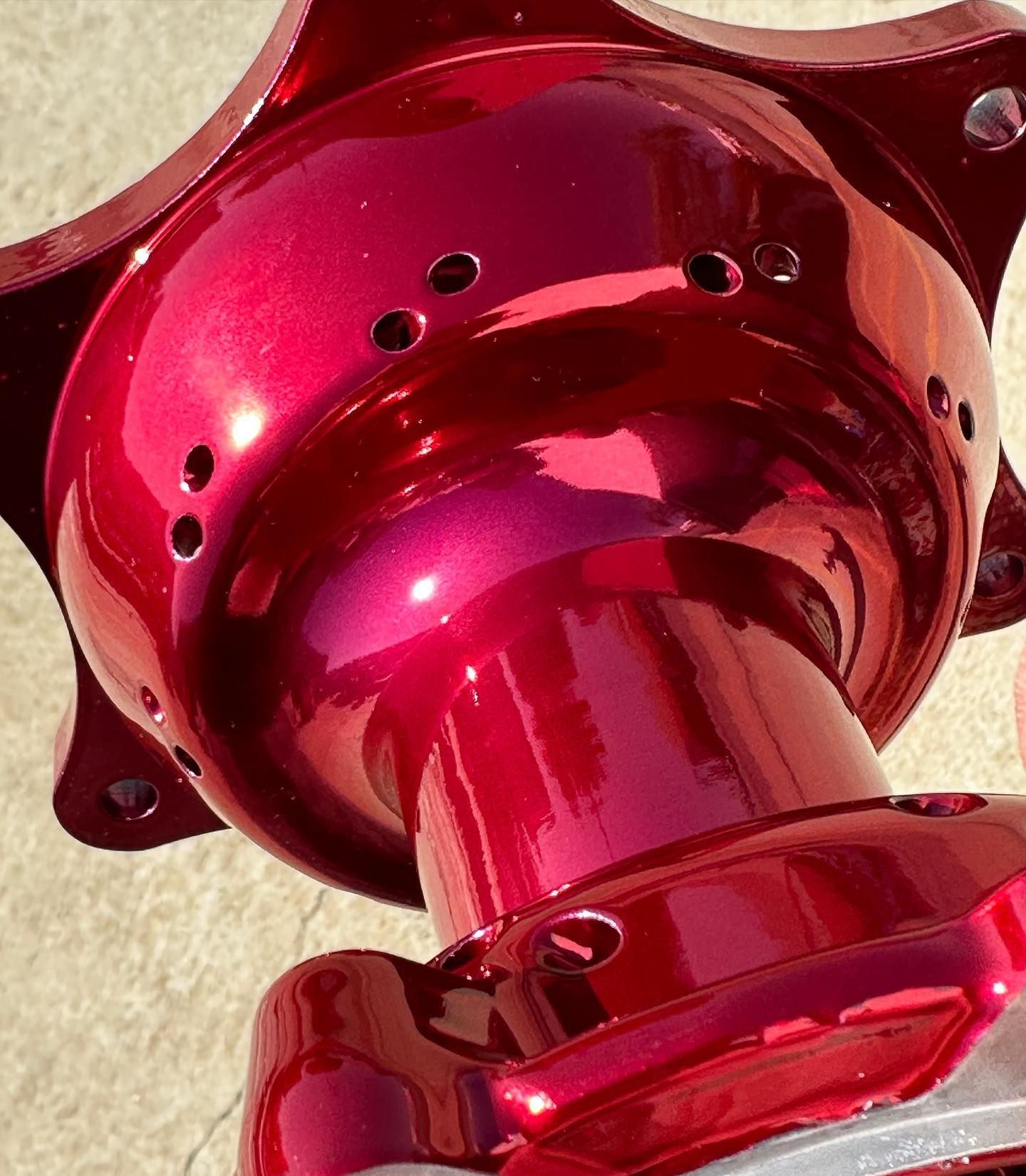 A close up of a red object with holes in it