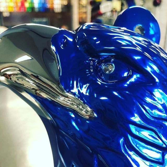 A close up of a blue and silver statue of an eagle