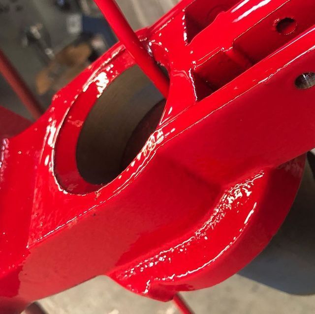 A close up of a red object with a hole in it