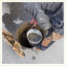 Cleaning sewer with bucket