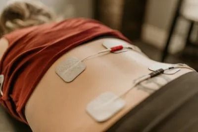 Person’s abdomen with medical electrodes attached during a procedure