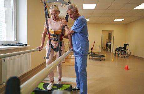 patient being assisted in physical therapy session