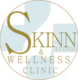 Logo for Skinn Studio & Wellness Clinic, gold and white text on light blue background within a circle.