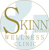 Logo for Skinn Studio & Wellness Clinic, gold and white text on light blue background within a circle.