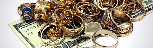 Dollar bills and gold jewelry