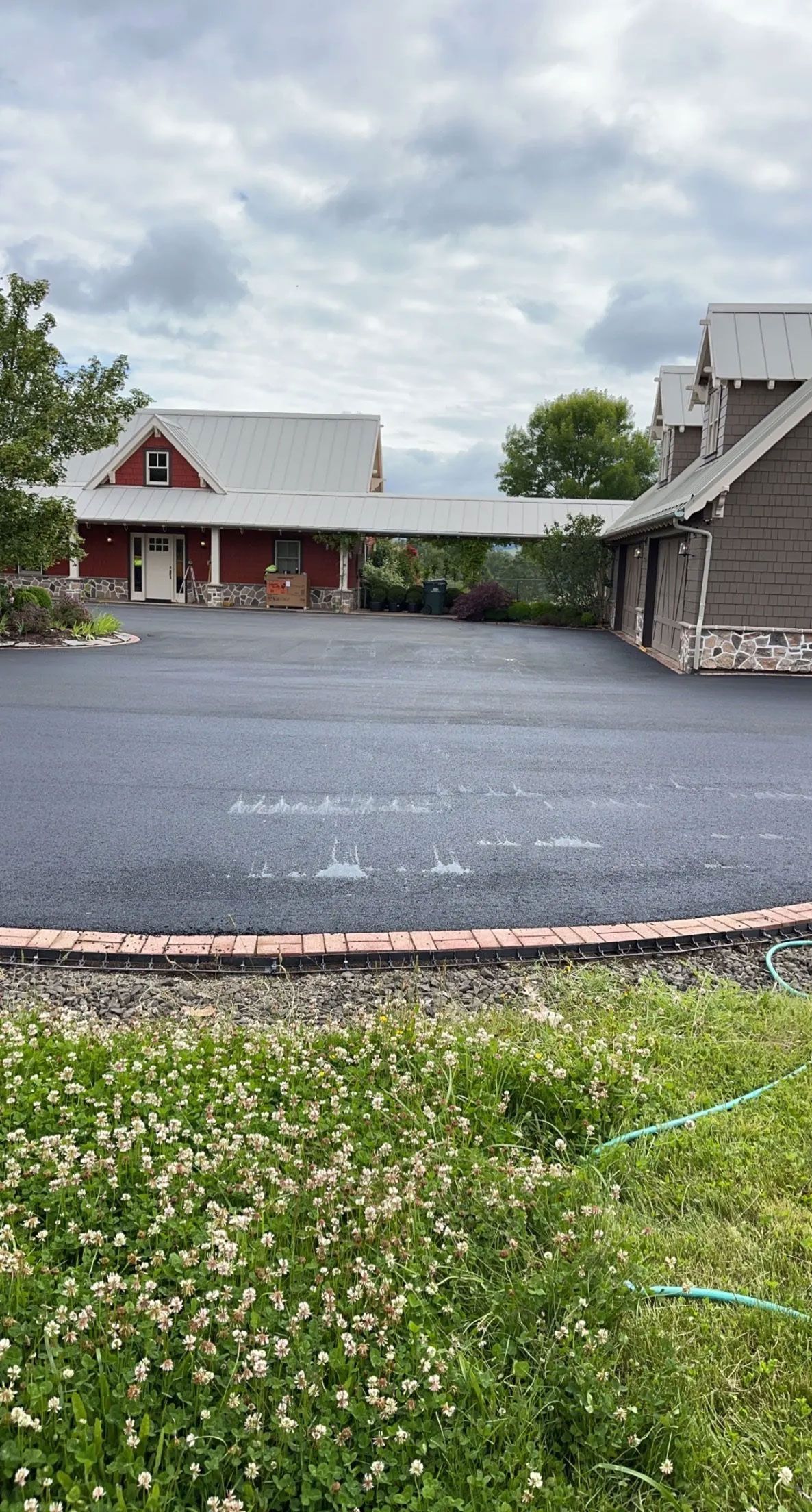 A large house with a large driveway in front of it.
