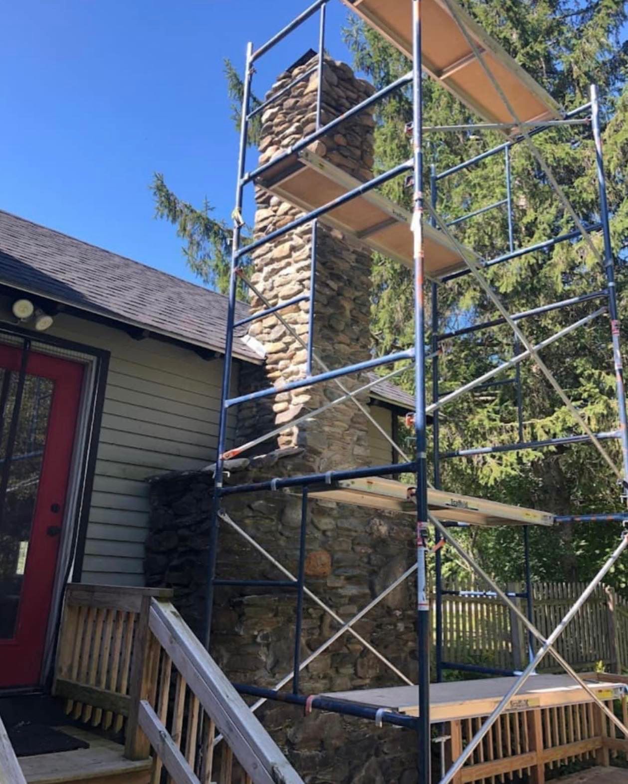Exterior residence chimney with scaffolding