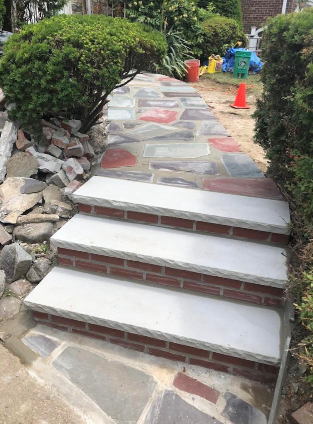 A stone walkway with brick steps leading up to a house