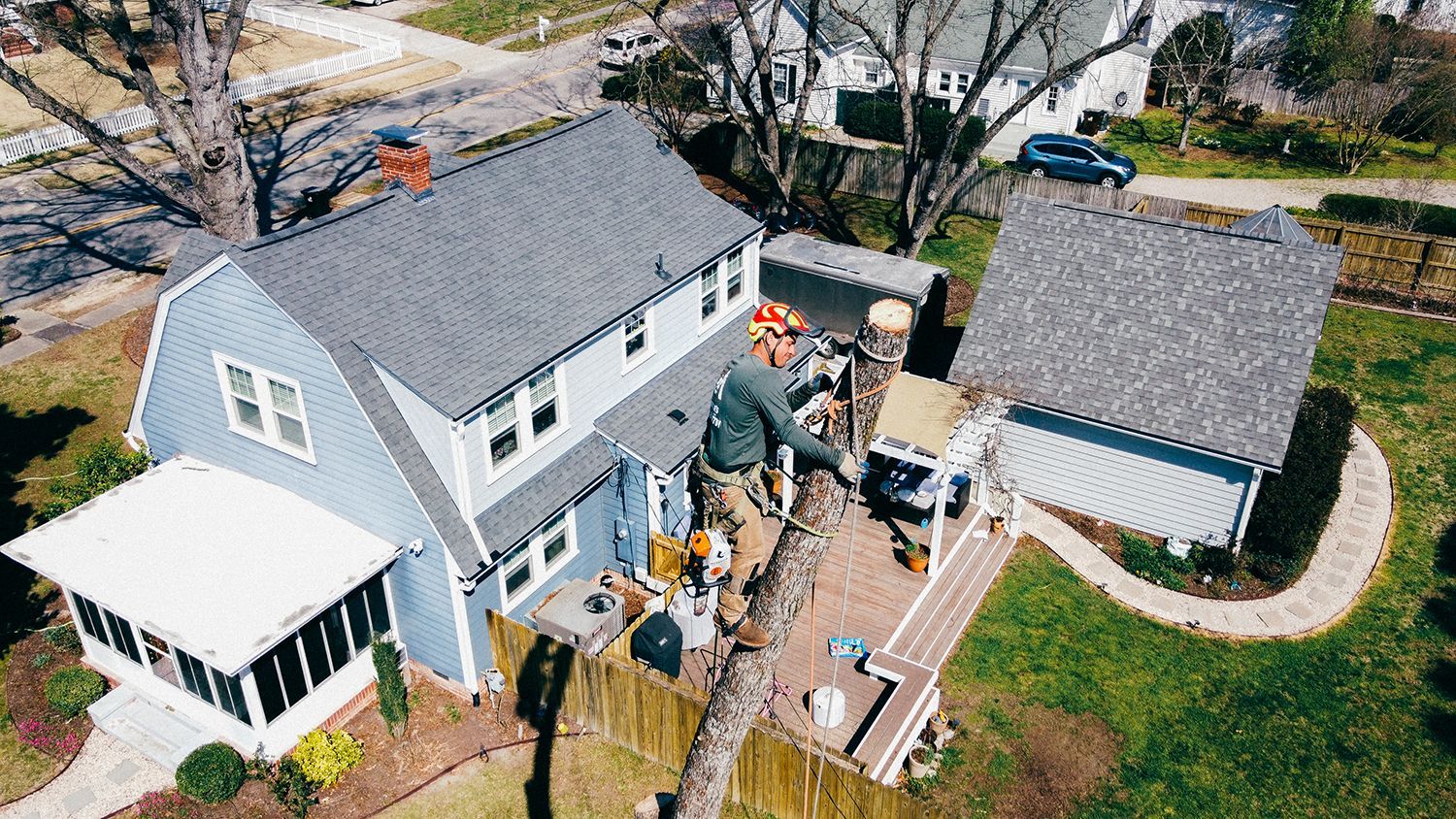 An aerial view of a house in a residential neighborhood.