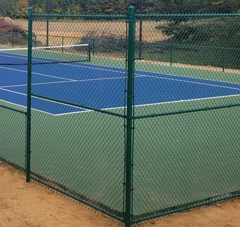 A tennis court with a chain link fence around it