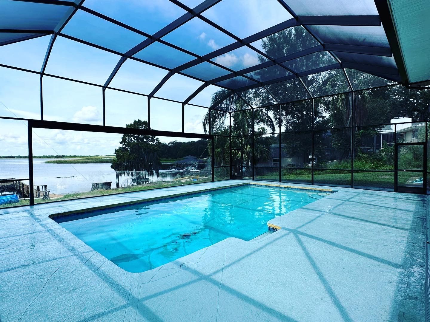 A large indoor swimming pool with a clear roof