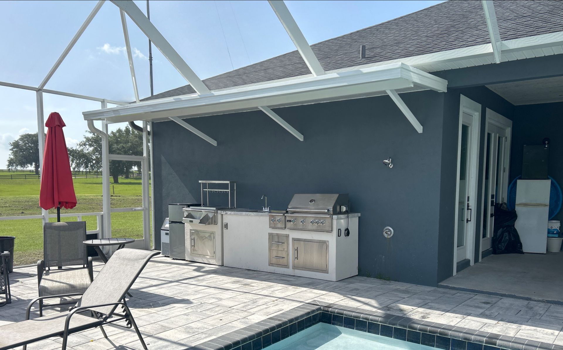 There is a swimming pool in the backyard of a house.