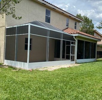 A house with a screened in porch in front of it