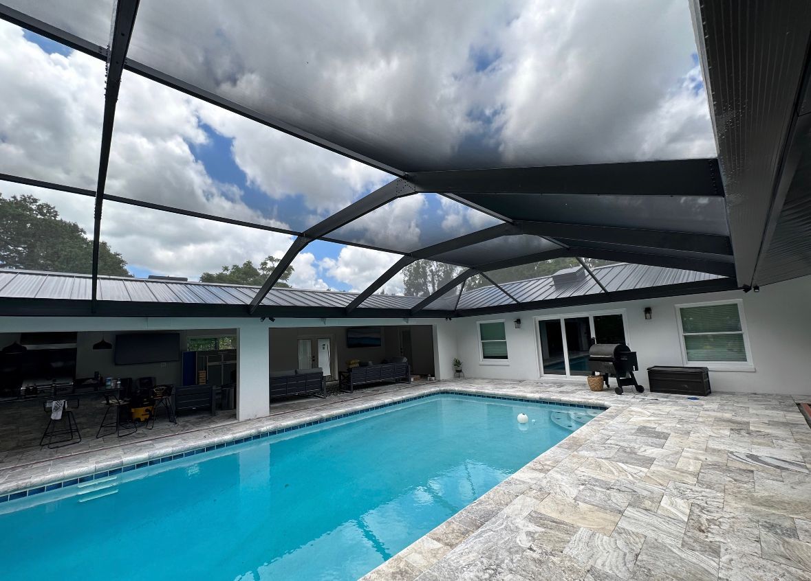 There is a large swimming pool in the backyard of a house.