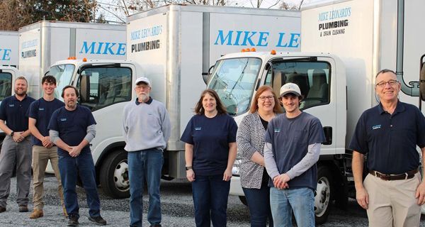 a group of people standing in front of trucks