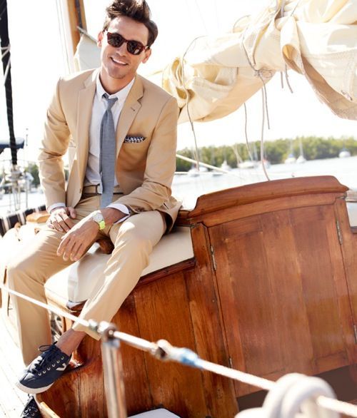 A man in a suit and tie is sitting on a boat