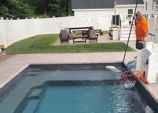 Colorful inflatable rings floating in a blue swimming pool.