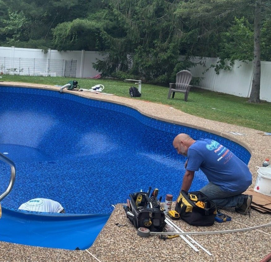 Family in yellow sunglasses on inflatable, smiling in a pool of water.