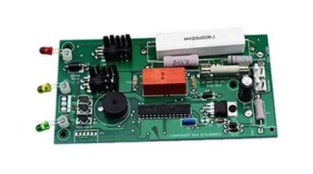 Green circuit board with various electronic components. Features LEDs, resistors, and an IC chip.