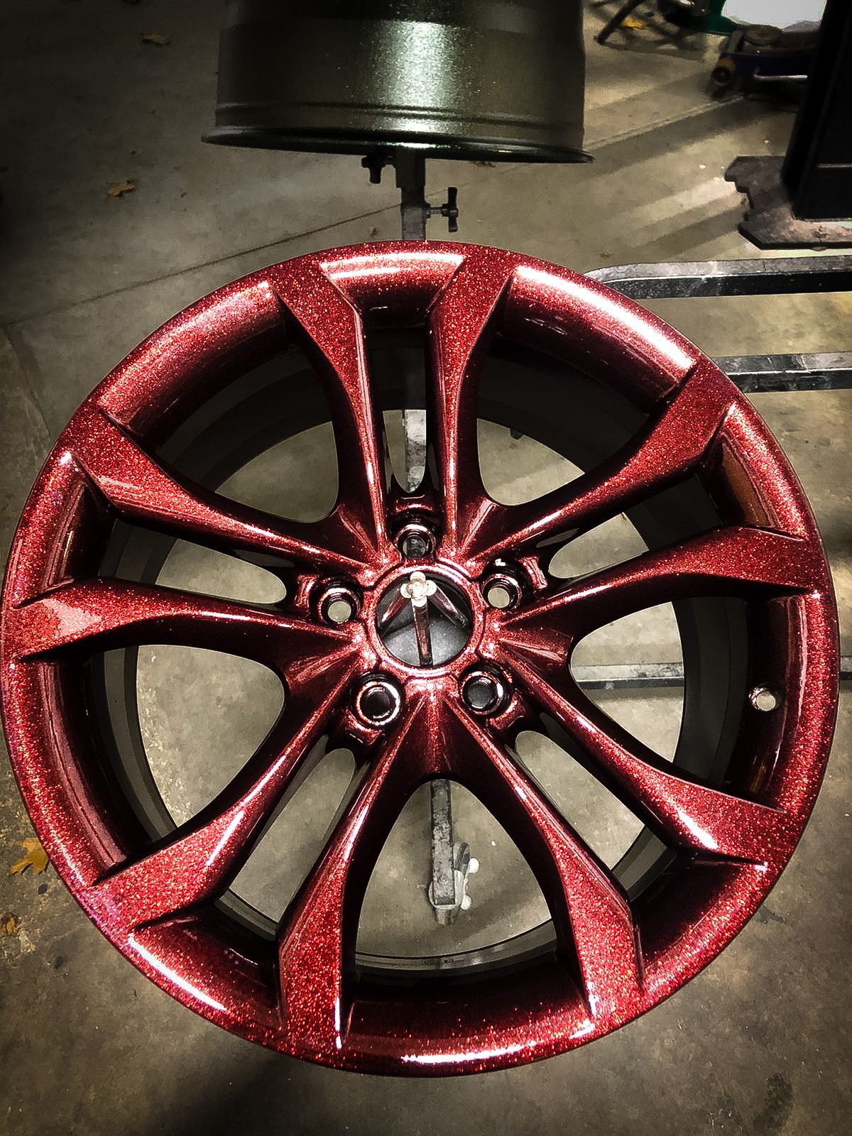 A close up of a red wheel with glitter on it