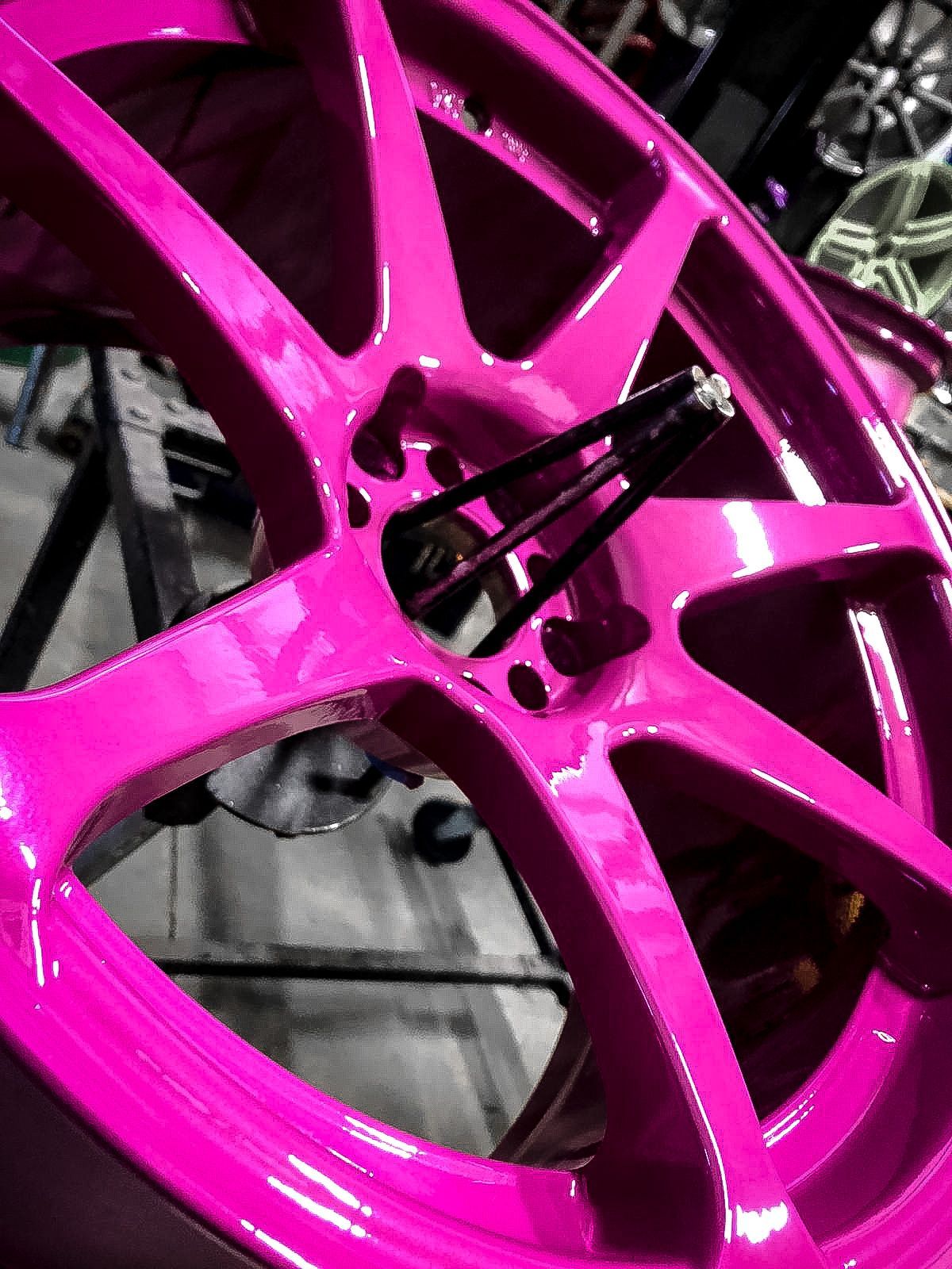 A close up of a pink wheel on a table