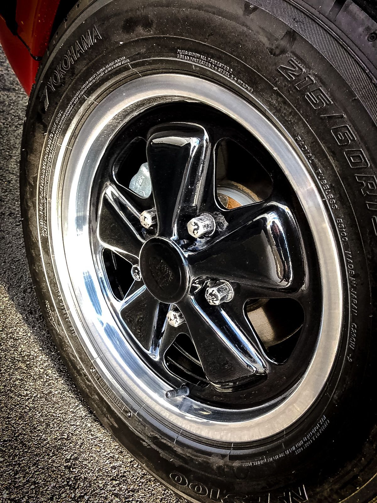 A close up of a car wheel with a tire on it