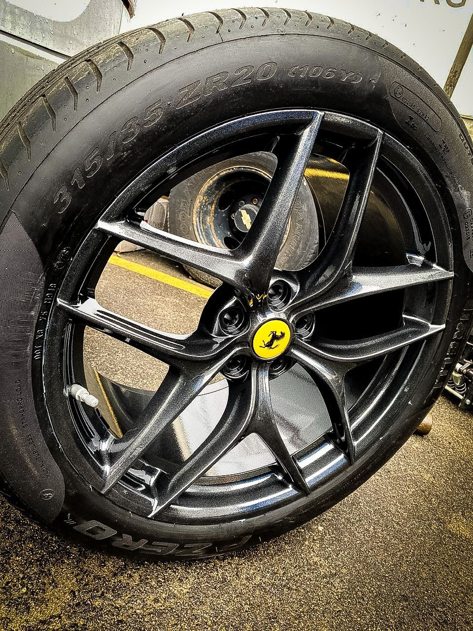 A close up of a ferrari wheel with a yellow y on it.