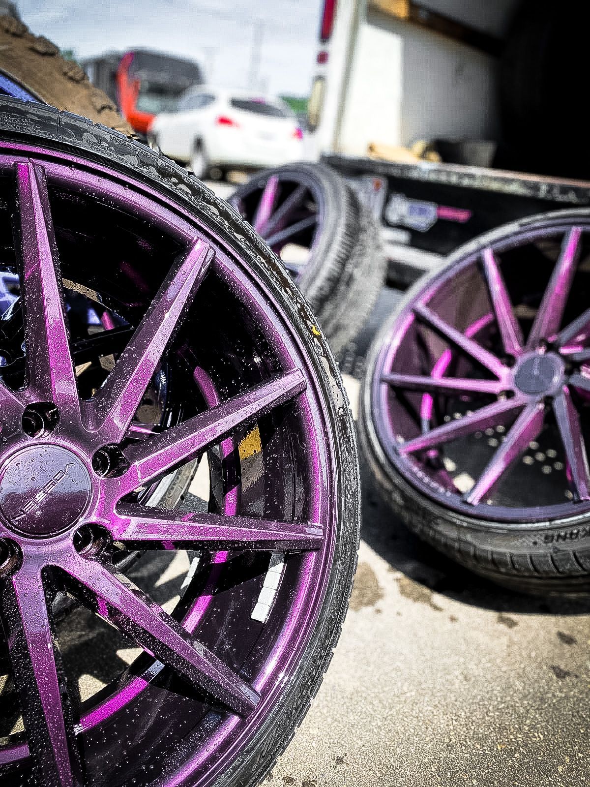 A close up of a purple wheel on a car.