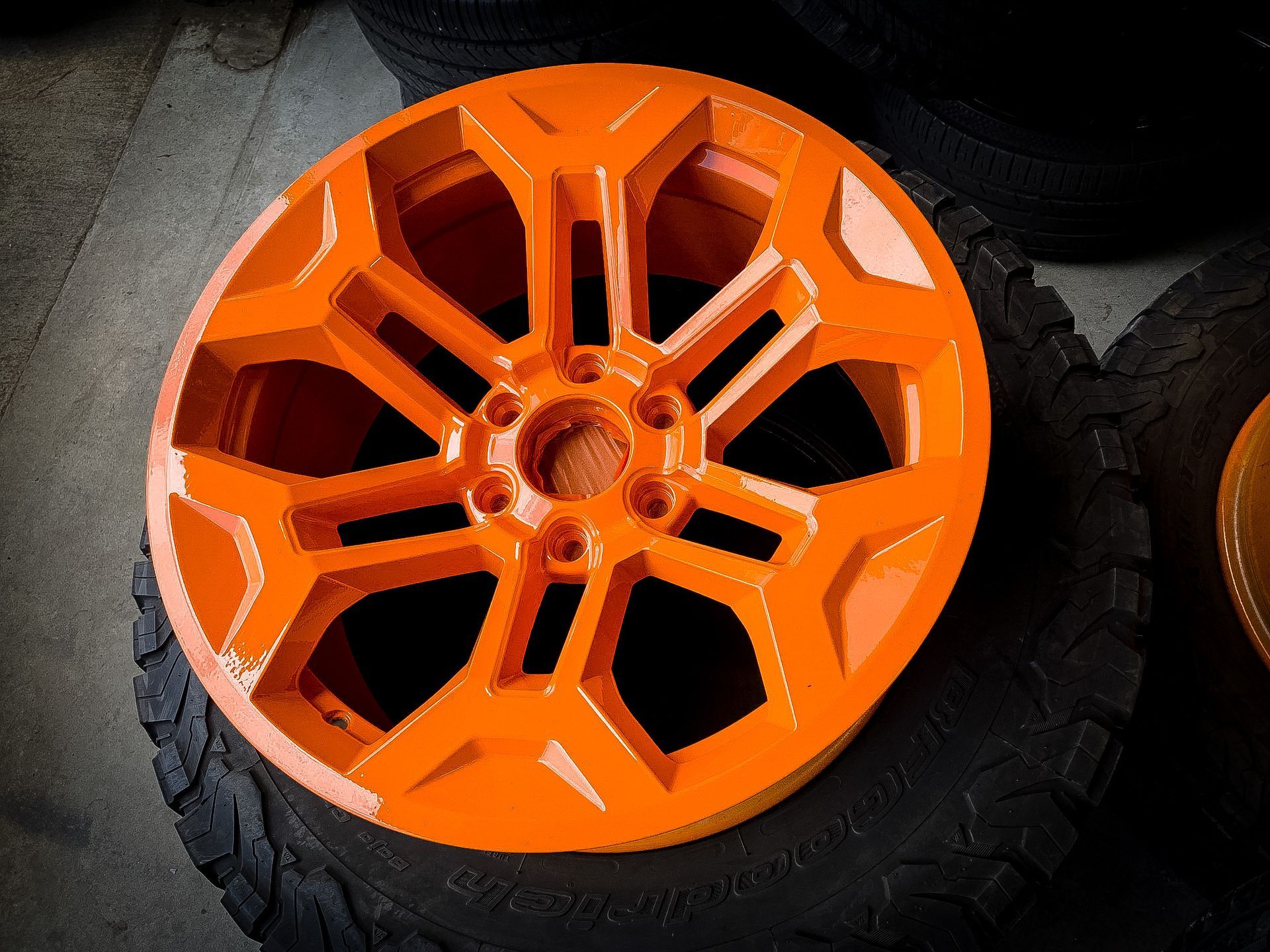 A close up of an orange wheel on a tire