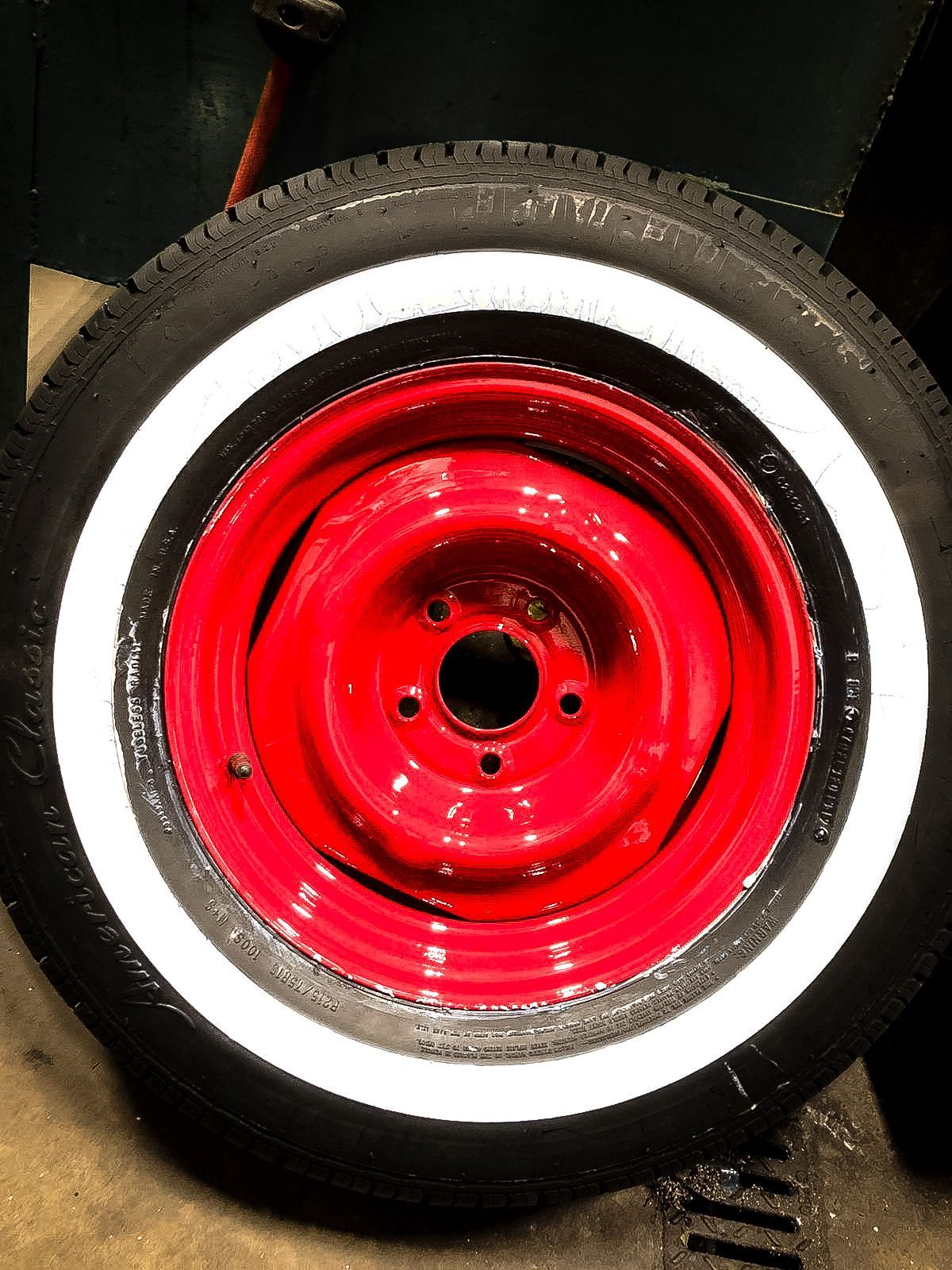 A red wheel with white tires on it