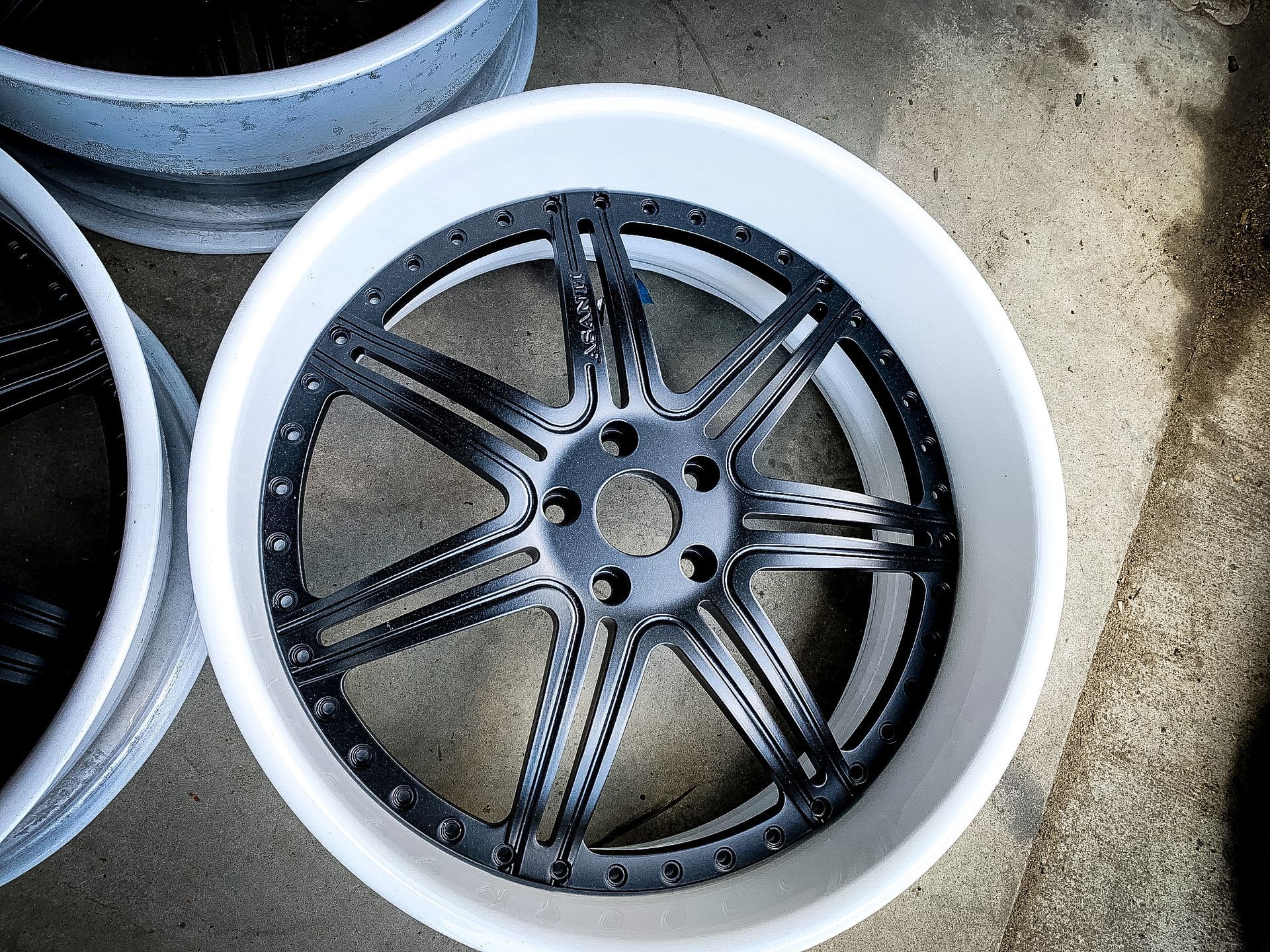 A close up of a wheel on a concrete surface.