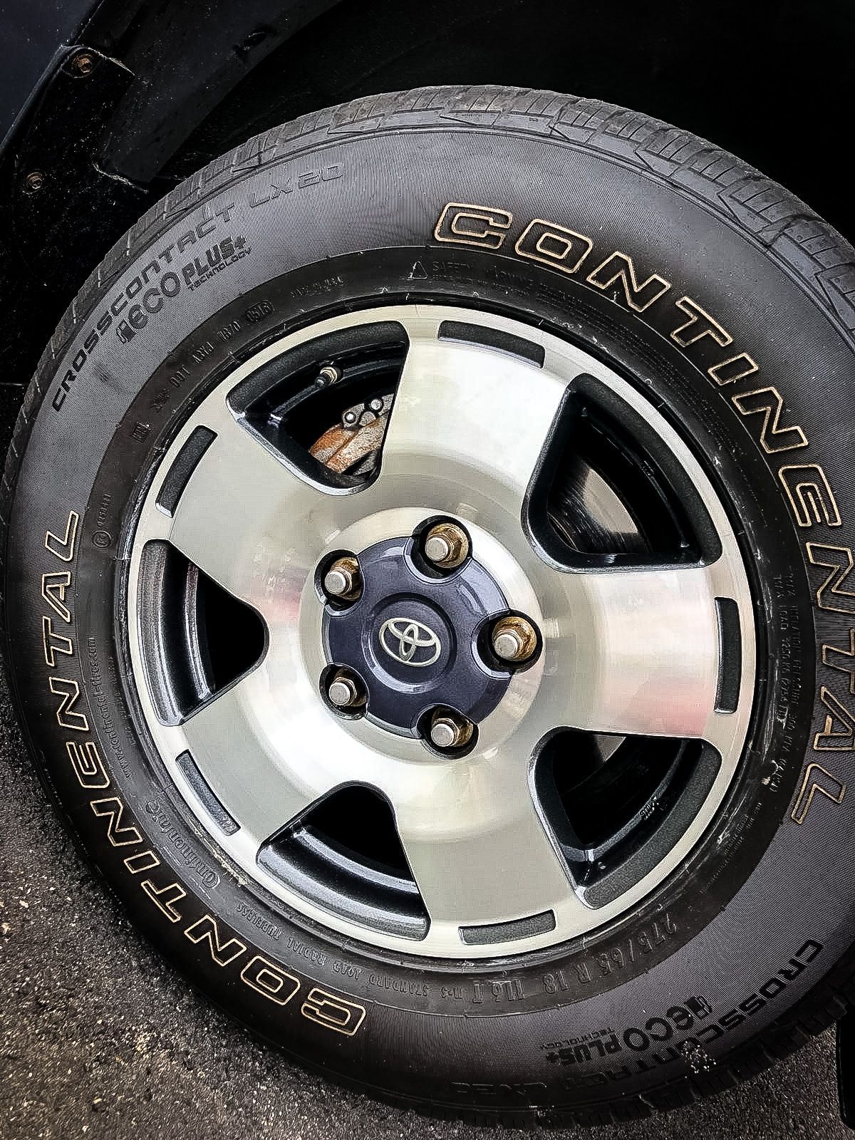 A close up of a continental tire on a car wheel