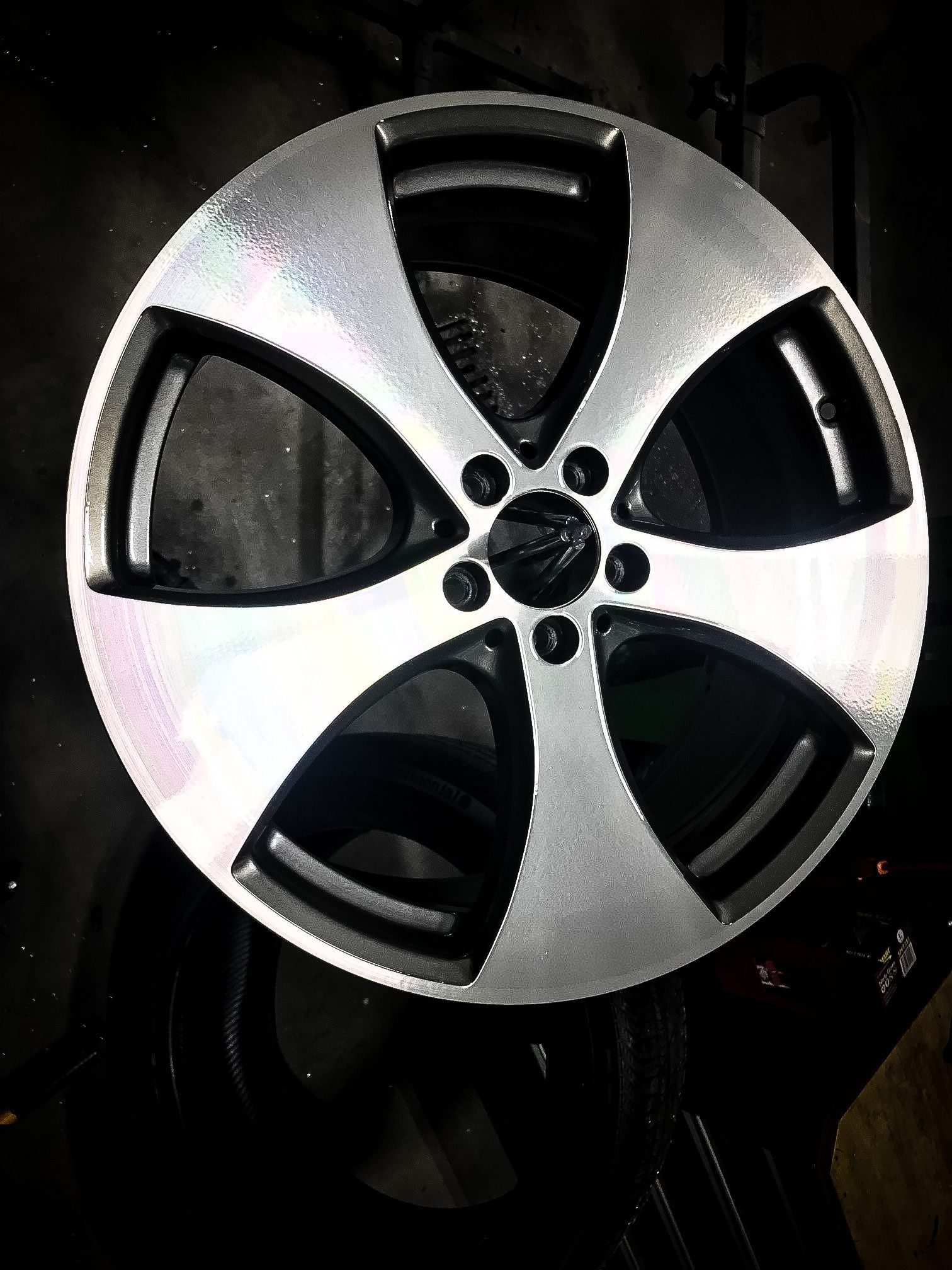 A close up of a car wheel on a black background