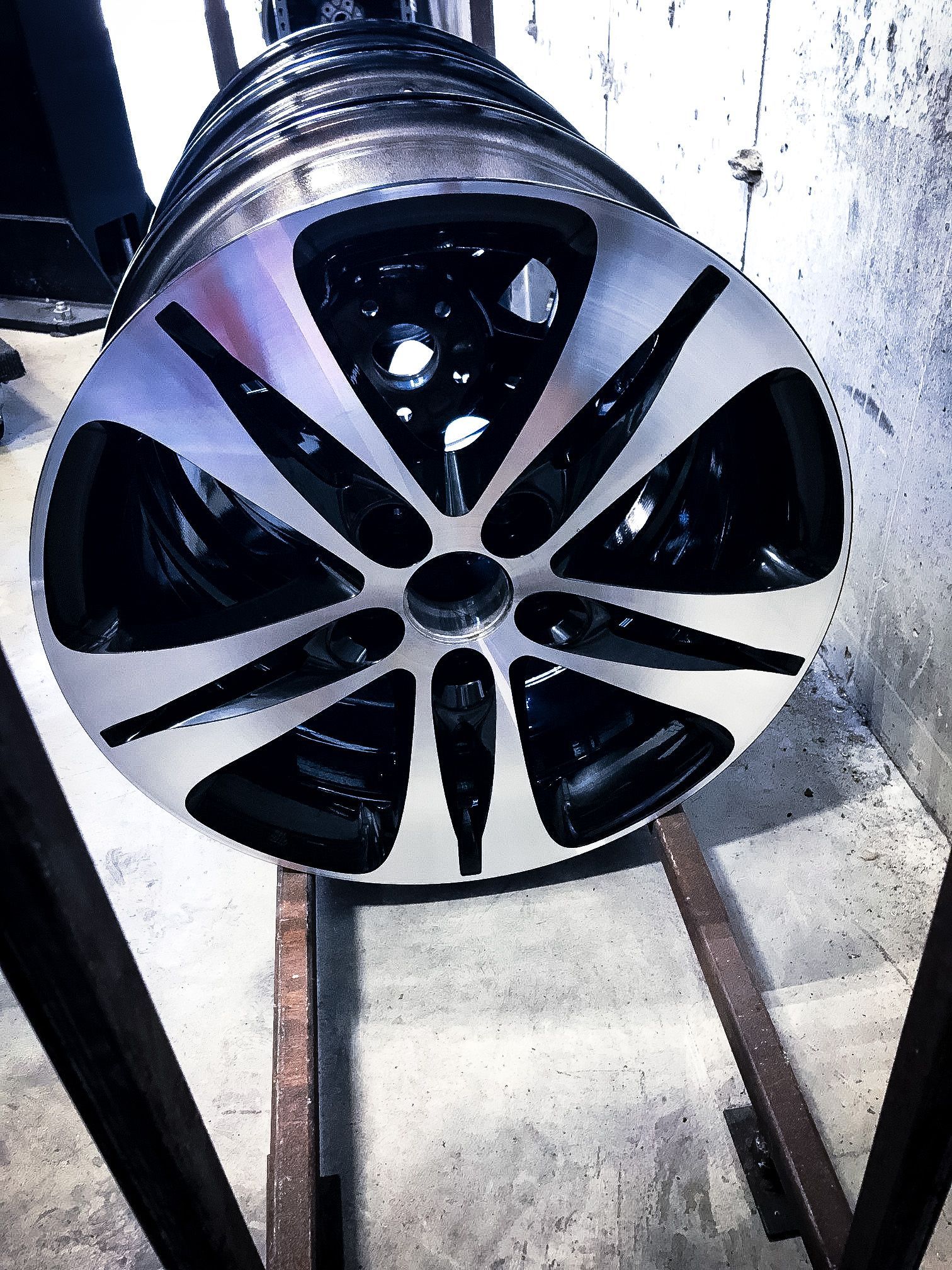 A close up of a car wheel on a metal stand