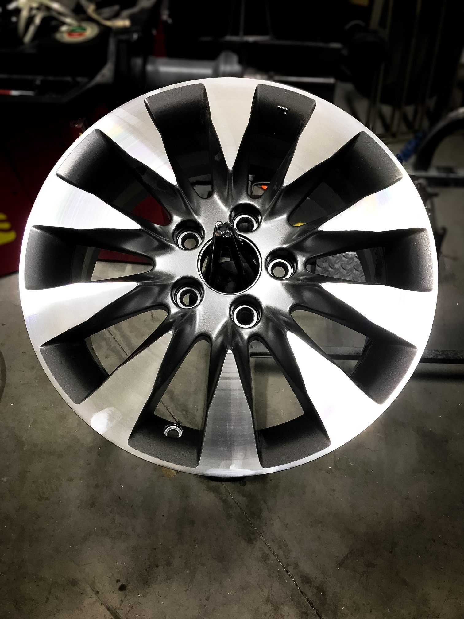 A black and silver wheel is sitting on a table.