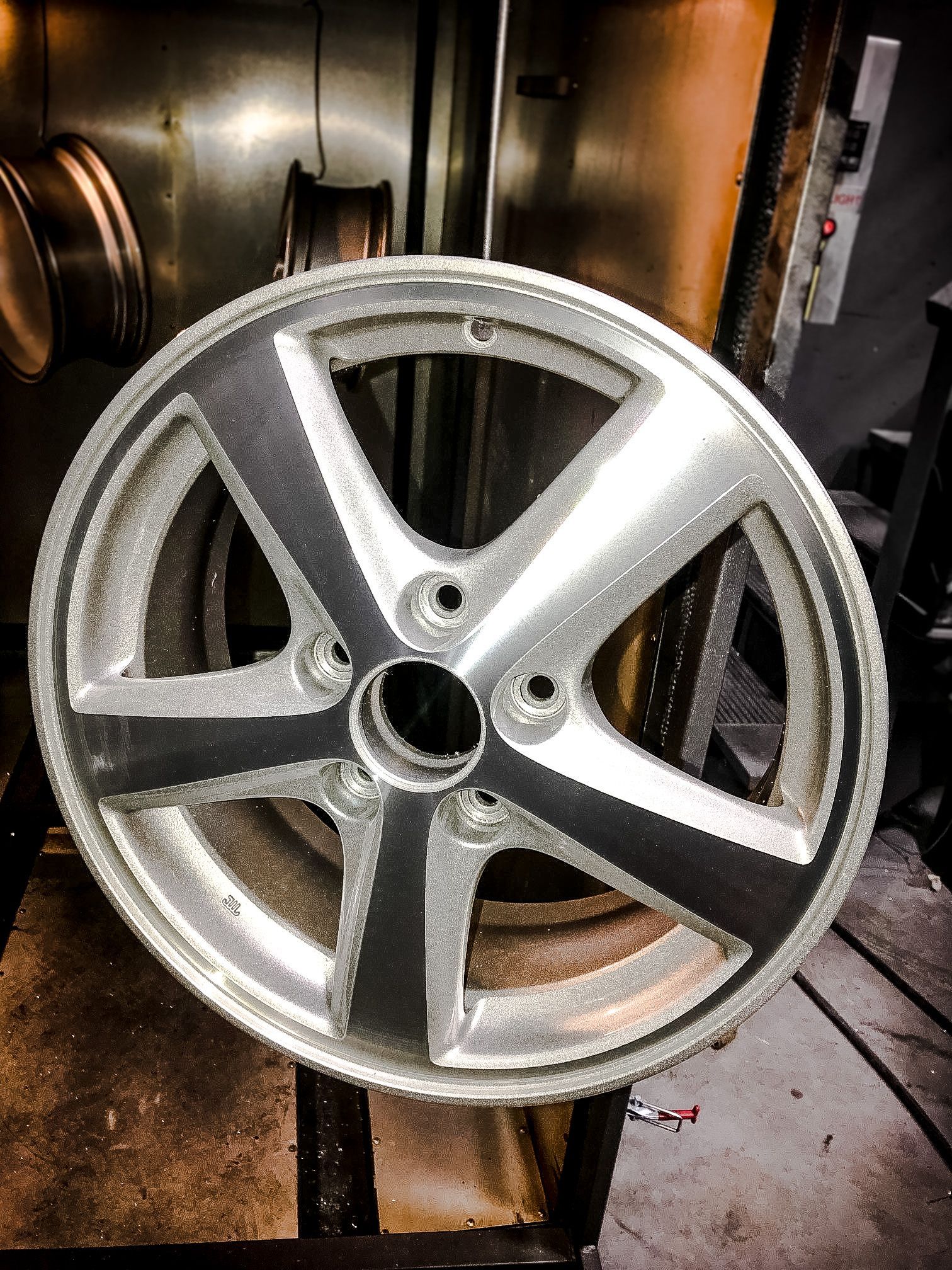 A close up of a car wheel sitting on top of a table.