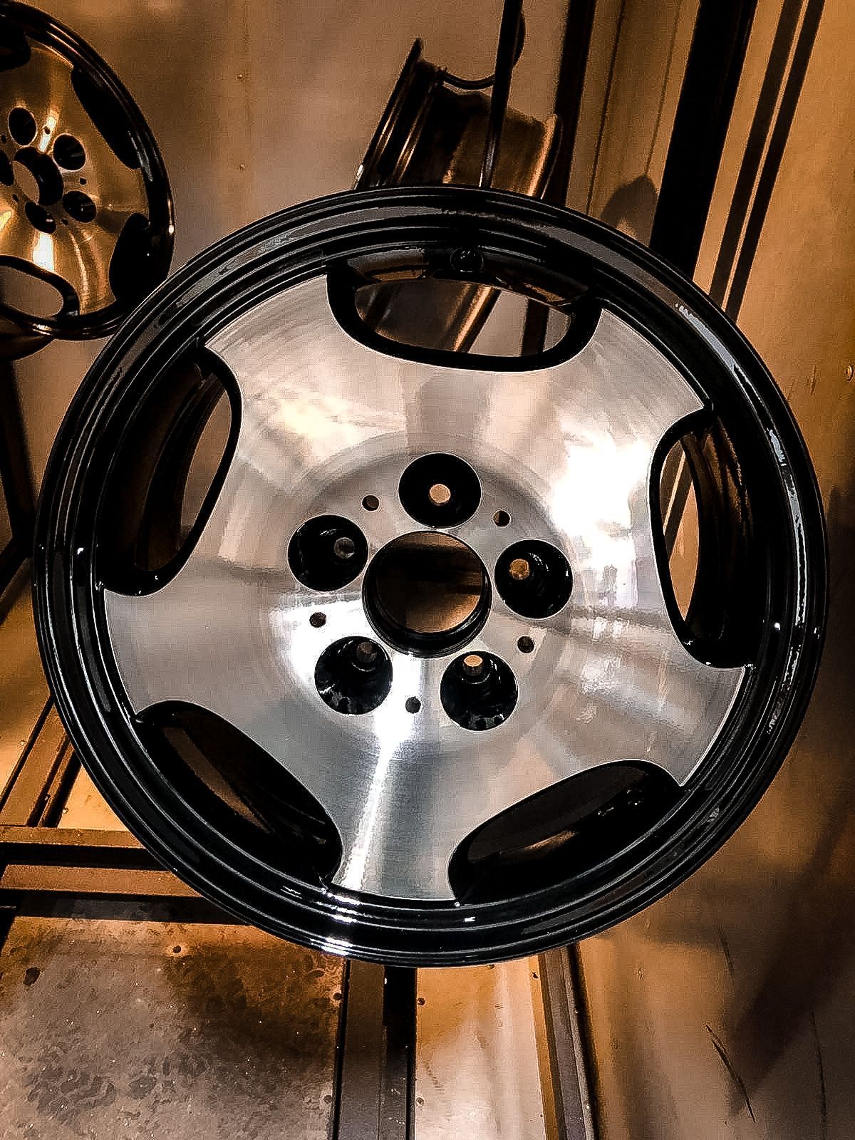 A close up of a car wheel with holes in it