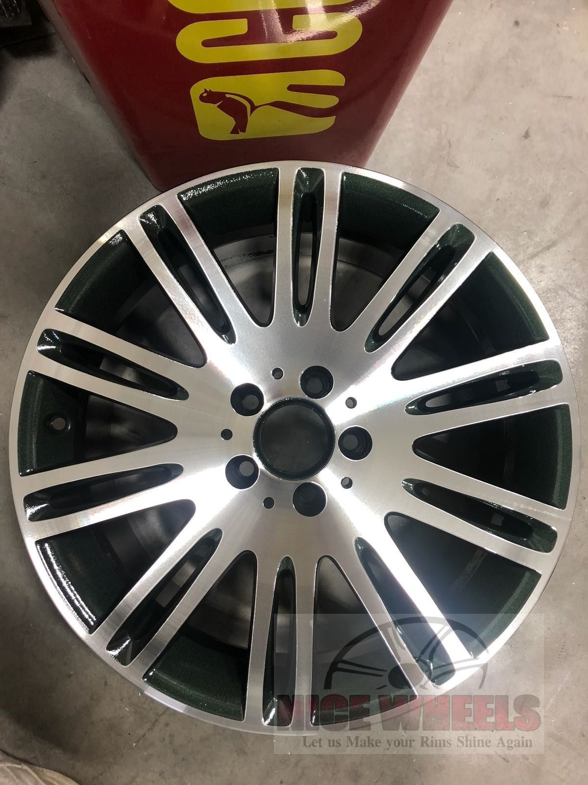 A close up of a car wheel on a concrete floor