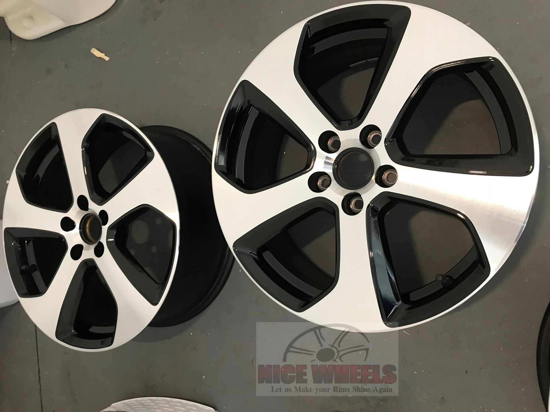 A pair of black and silver wheels from nice wheels