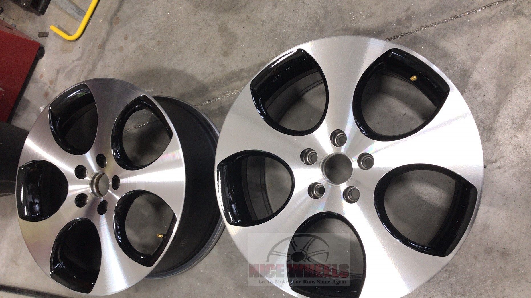 A pair of black and silver wheels on a concrete surface