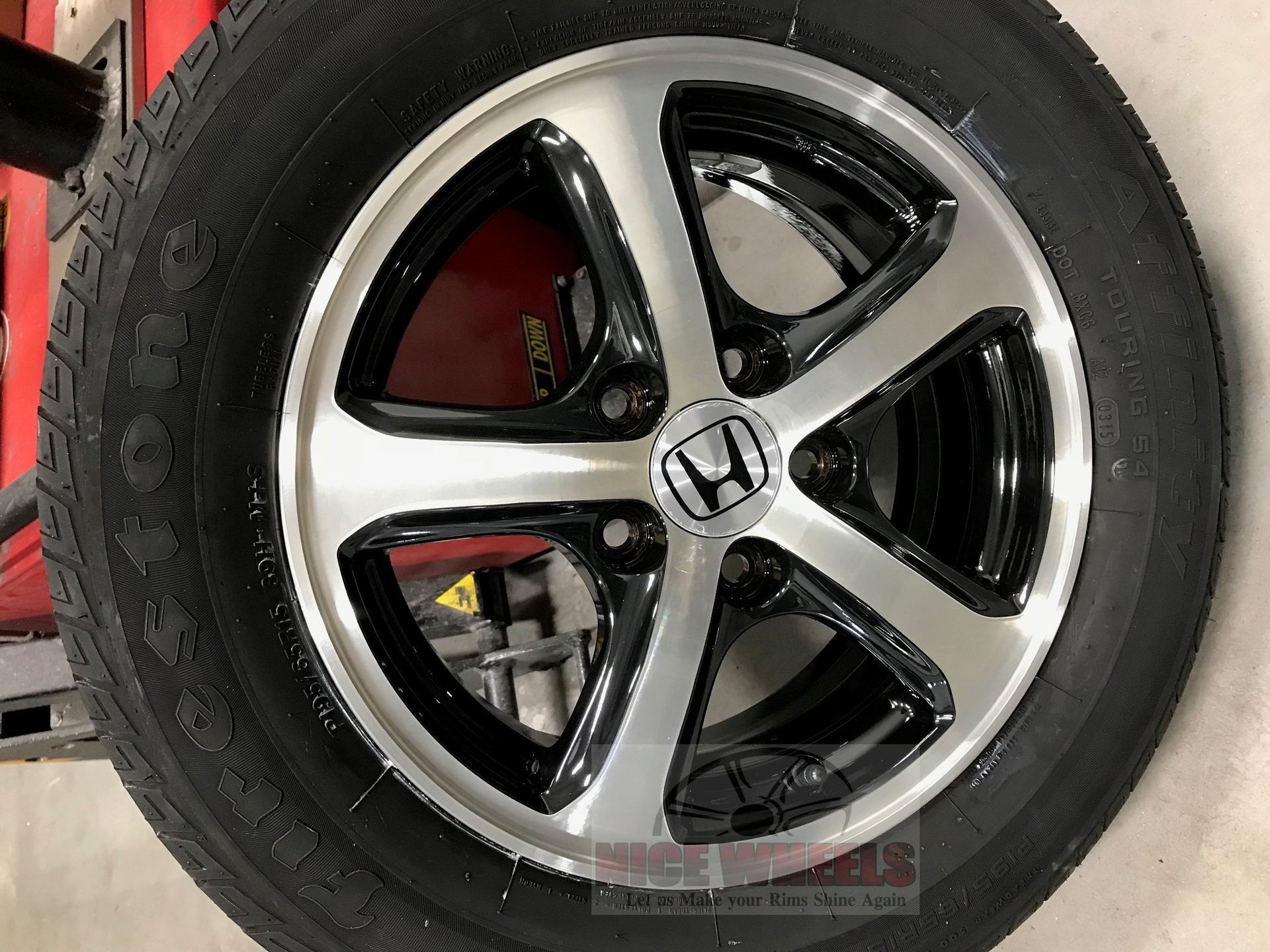 A close up of a honda wheel and tire