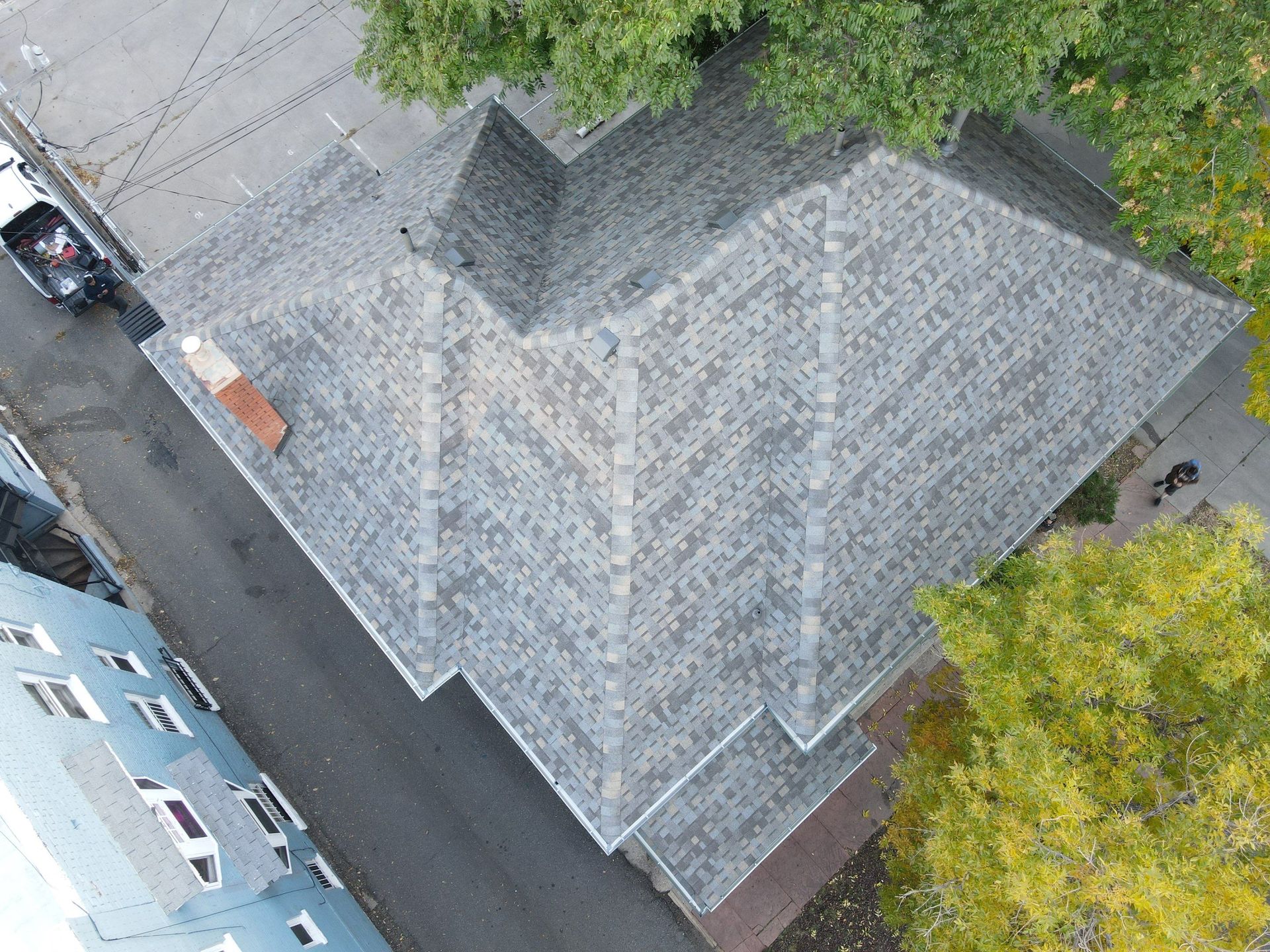 An aerial view of a house with a roof and a chimney.