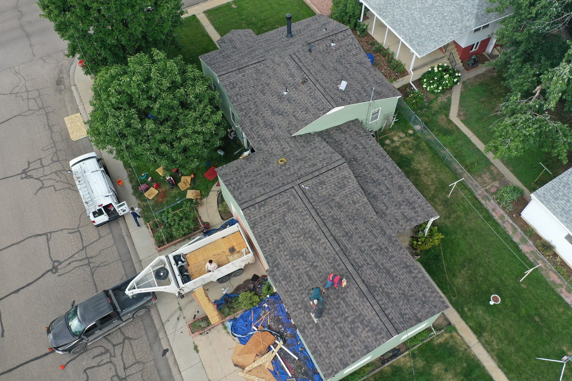 An aerial view of a roof being installed on a house.